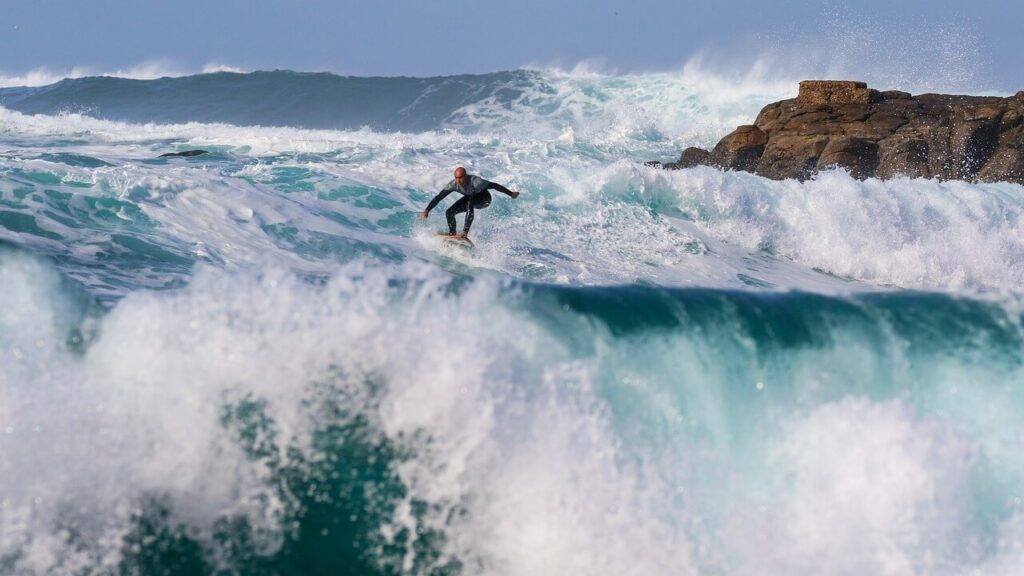 Kalihiwai Beach: Insider's Guide to a Hidden Hawaiian Gem 3 surffing